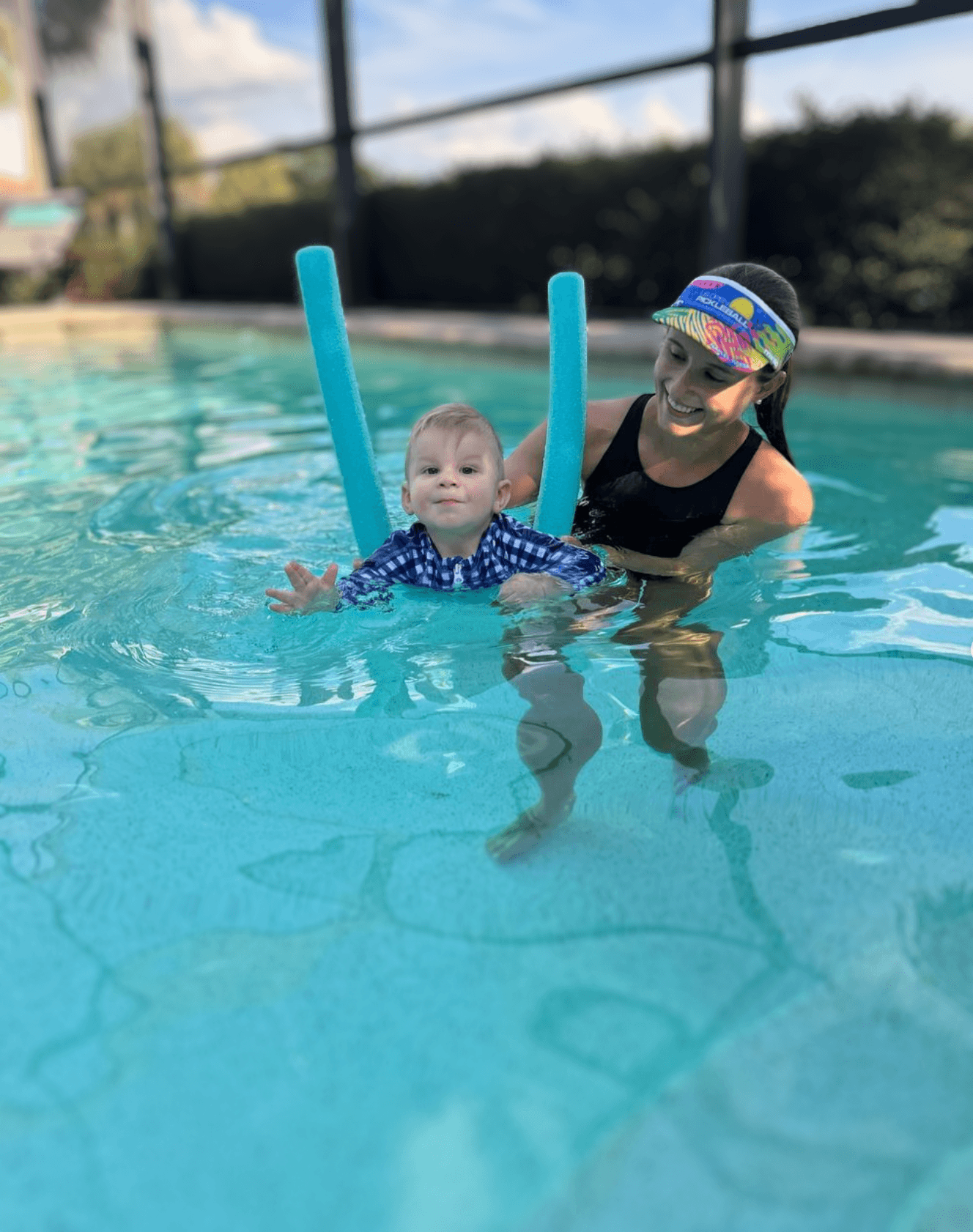 Dr. Amanda Clarke supporting an infant learning to float