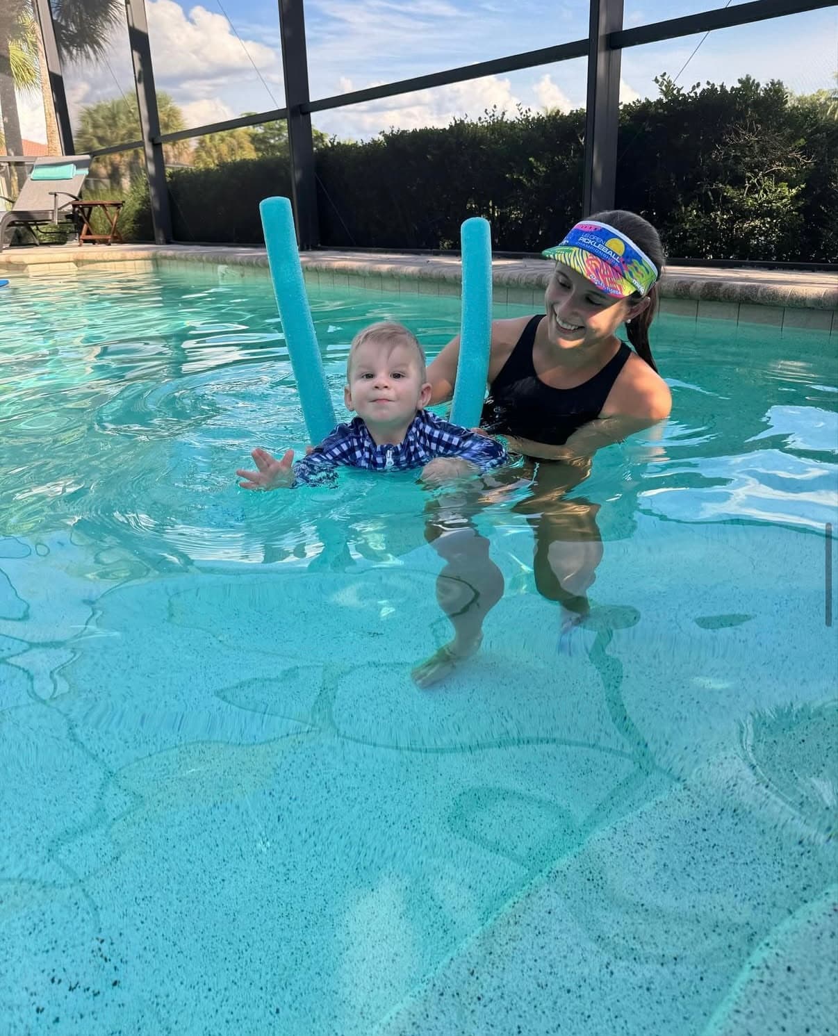 Dr. Amanda Clarke supporting an infant between two pool noodles